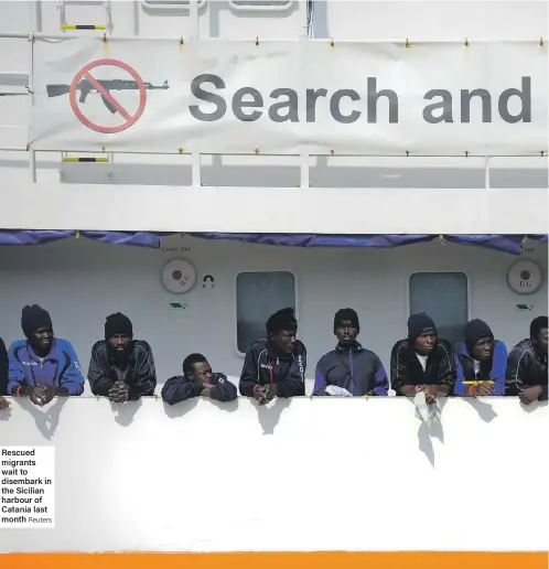  ?? Reuters ?? Rescued migrants wait to disembark in the Sicilian harbour of Catania last month