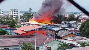  ??  ?? Flaming devastatio­n: More than 2,000 people were left homeless after a fire destroyed the old floating village in Semporna.