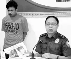  ?? — Reuters photo ?? A police officer presents to the media, Mohammad Noaim Maute, who was arrested at a checkpoint in Cagayan De Oro city, Philippine­s.