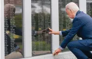  ?? Photo: AP ?? President Joe Biden reaches to touch the name of his uncle, Ambrose J. Finnegan, at the war memorial in his hometown of Scranton.