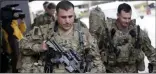  ?? CHRIS SEWARD- ASSOCIATED PRESS ?? U.S. Army soldiers with their gear head to an awaiting bus Saturday at Fort Bragg, N.C., as troops from the 82nd Airborne are deployed to the Middle East as reinforcem­ents in the volatile aftermath of the killing of Iranian Gen. Qassem Soleimani.