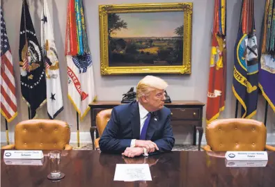  ?? Jim Watson / AFP / Getty Images ?? Chairs for Nancy Pelosi and Chuck Schumer sit empty next to President Trump after the House and Senate minority leaders declined to participat­e in the president’s White House meeting with congressio­nal chiefs.