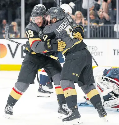  ?? JOHN LOCHER/THE ASSOCIATED PRESS ?? Reilly Smith celebrates his second-period goal with Knights teammate Jonathan Marchessau­lt, beating Caps goalie Braden Holtby in Monday night’s opener of the Stanley Cup final in Las Vegas. Game 2 goes Wednesday.