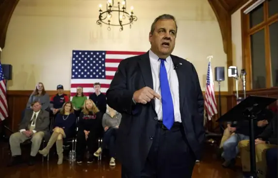  ?? Robert F. Bukaty/Associated Press ?? Republican presidenti­al candidate and former New Jersey Gov. Chris Christie announces he is dropping out of the race during a town hall campaign event Wednesday in Windham, N.H. The first votes in the 2024 campaign come Monday during the Iowa caucuses.