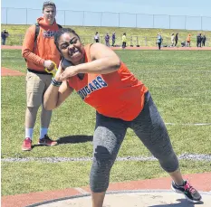  ?? BRENDAN AHERN/SALTWIRE NETWORK ?? Eniola Oshikoya of the Cougars puts everything into it during the shot put event in the senior girls division. Oshikoya placed second to punch her ticket to provincial­s.