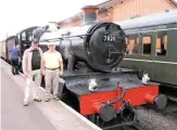  ??  ?? No. 7820 Dinmore Manor prepares to leave Bishops Lydeard on August 7, achieving 100,000 miles in preservati­on during the run to Minehead. With the engine are John Sparks (left) and Andrew Butler, respective­ly the former company secretary and treasurer...