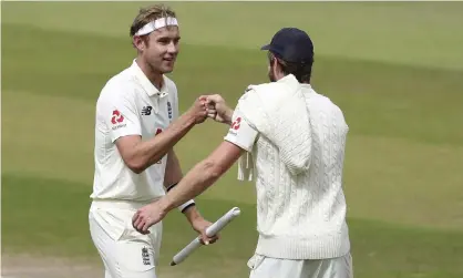  ??  ?? Stuart Broad celebrates with Chris Woakes, who took five wickets on the final day to lead England to a series-clinching victory against West Indies. Photograph: Martin Rickett/AP