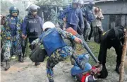  ?? The Associated Press ?? Bangladesh­i police kick a suspect after an attack Sunday on a polling station in Bogra, Bangladesh.