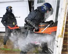  ??  ?? Above: Officers cut their way into a suspect’s house Right: Miss Patel with police chief Andy Cooke