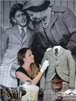  ?? PICTURE: REUTERS ?? Curator of the Royal Collection Trust Anna Reynolds with a kilt in balmoral tartan and jacket belonging to Prince Charles from 1958 at Buckingham Palace.