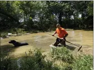  ?? JOHN AMIS — THE ASSOCIATED PRESS ?? Dustin Shadownes, of Ashland City Fire Department, searches a creek for missing persons along with a cadaver dog Aug. 23 in Waverly, Tenn.