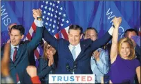  ?? PAUL SANCYA/THE ASSOCIATED PRESS ?? Republican presidenti­al candidate Ted Cruz raises hands with Wisconsin Gov. Scott Walker, left, and his wife, Heidi.