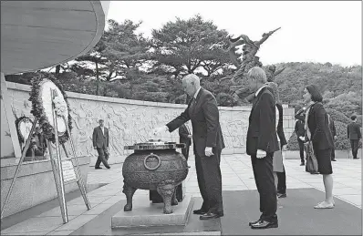  ?? [AHN YOUNG-JOON/THE ASSOCIATED PRESS] ?? Vice President Mike Pence, center, lights incense at the National Cemetery in Seoul, South Korea, on Sunday. Pence has begun a 10-day trip to Asia that comes amid turmoil on the Korean Peninsula over North Korea’s threats to advance its nuclear and...