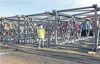  ??  ?? OilMac managing director Alex Fyfe with some of the sections for the 115 metre main mast.