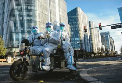  ?? NOEL CELIS/GETTY-AFP ?? People in personal protective gear Saturday on a street in Beijing. China’s “zero-COVID” policy appears to be failing.