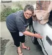  ??  ?? Daphne George, of Oamaru, shows the damage to her car.