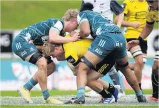  ?? PHOTO: GETTY IMAGES ?? No way through . . . Highlander­s players Sean Withy (left) and Arese Poliko tackle Ben Strang, of the Hurricanes, during a Super Rugby Aotearoa under20 match at Owen Delany Park in Taupo yesterday.