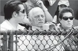  ?? James A. Finley Associated Press ?? PETER ANGELOS with his son Louis and wife, Georgia, during spring training in 2007. Angelos endured many losing seasons with his hometown Baltimore team.