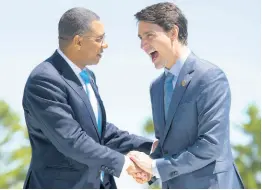  ?? AP ?? In this June 2018 file photo, Canada’s Prime Minister Justin Trudeau (right) shakes hands with Jamaica’s Prime Minister Andrew Holness as he welcomes representa­tives from outreach countries and internatio­nal organisati­ons during the G-7 summit in La Malbaie, Quebec.