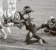  ?? Ben Margot / Associated Press ?? Colts running back Nyheim Hines, left, dives past Titans cornerback Malcolm Butler for a touchdown.