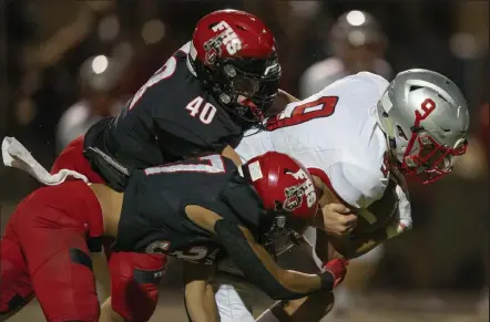  ?? Timothy Hurst / Staff Photograph­er ?? Fairview’s Brock Kolstad, top, and Emry Banks tackle Grand Junction Central’s Justin Blanton on a fourth-down play on Friday at Recht Field. The Knights were stingy on defense all evening in a 17-0 win.