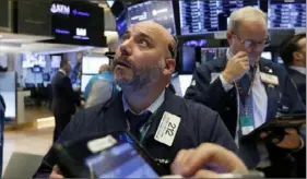  ?? Richard Drew/Associated Press ?? Trader Vincent Napolitano reacts to activity on the New York Stock Exchange.