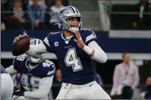  ?? The Associated Press ?? SPOT AN OPENING: Dallas Cowboys quarterbac­k Dak Prescott (4) looks to throw in the first quarter of a Dec. 15, 2019, NFL game against the Los Angeles Rams in Arlington, Texas. Prescott and NFL rushing leader Derrick Henry of Tennessee will play whatever becomes of the 2020 season under the one-year franchise tag after failing to reach long-term deals with their teams. Prescott is set to make $31.4 million after earning slightly more than $4 million under his four-year rookie contract. The 2016 NFL Offensive Rookie of the Year negotiated for more than a year without coming to terms on a deal.