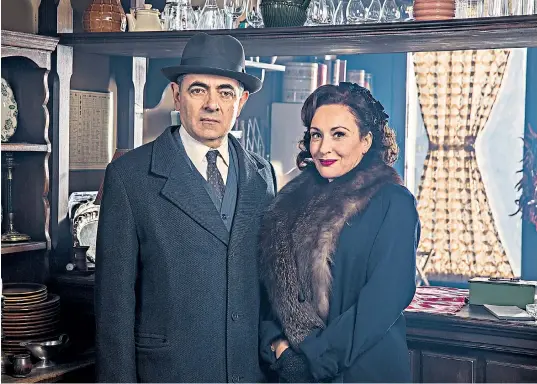  ??  ?? A stern-looking Inspector Jules Maigret (Rowan Atkinson) and Madame Maigret (Lucy Cohu) in the ITV drama