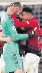  ??  ?? Jesse Lingard congratula­tes David de Gea after the win at Spurs