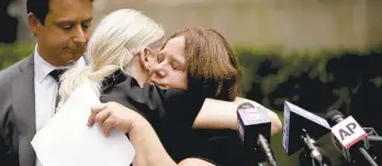  ?? ROBERT BUMSTED/AP ?? Joanne Schoonmake­r, right, is consoled by her attorney Sarah Klein at a news conference outside the New York City Department of Education headquarte­rs on Wednesday. Following the implementa­tion of the New York Child Victims Act, Schoonmake­r filed a lawsuit alleging she was raped by a janitor at Wellsville Middle School in Wellsville, N.Y. starting at the age of 12.