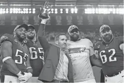  ?? MATT SLOCUM/AP ?? Eagles general manager Howie Roseman, center, celebrates with players, from left, Brandon Graham, Lane Johnson, Fletcher Cox and Jason Kelce after their NFC championsh­ip win over the 49ers on Jan. 29.