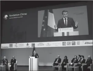  ?? The Associated Press ?? INVESTOR OPTOMISM: French President Emmanuel Macron delivers his speech at the Fondation Chirac Prize ceremony at Quai Branly Museum on Thursday in Paris. The Fondation Chirac Prize is awarded to one or more private individual­s and aims to improve...