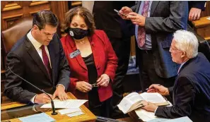  ?? PHOTOS BY ALYSSA POINTER/ALYSSA.POINTER@AJC.COM ?? Lt. Gov. Geoff Duncan (left) writes notes before the start of a debate on SB 202 in the Senate chambers at the state Capitol on Thursday. SB 202 passed the Senate and House chambers and was signed into law by Gov. Brian Kemp.