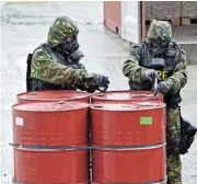  ?? /Bloomberg ?? Lethal: Singapore soldiers take a sample from barrels in a shipping container suspected of carrying prohibited chemicals.