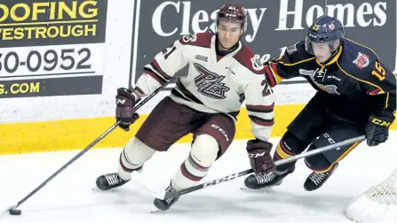  ?? CLIFFORD SKARSTEDT/EXAMINER FILES ?? Peterborou­gh Petes top scorer Jonathan Ang eludes Barrie Colts' Jaden Peca during first period OHL action on Nov. 4 at the Memorial Centre. Ang is one of 32 players named to Canada's national junior team selection camp next week in St. Catharines.