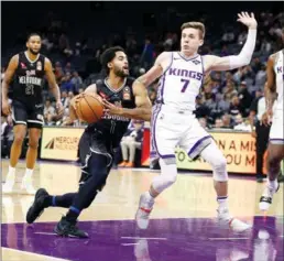  ?? Getty Images/tns ?? The Sacramento Kings’ Kyle Guy (7) defends against a drive by Melbourne United’s Melo Trimble on October 16, 2019, in Sacramento.