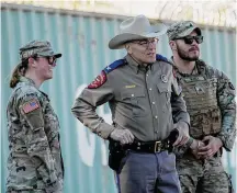  ?? Eric Gay/Associated Press ?? Texas Department of Public Safety Director Steve McCraw, center, stands with officials as they wait for the arrival of congressio­nal members on Jan. 3 in Eagle Pass.