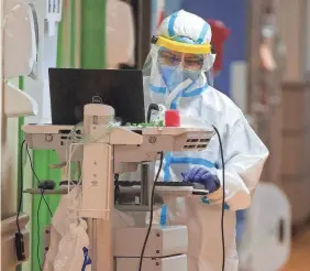  ??  ?? A medical staff member at Val Verde Regional Medical Center works on a COVID-19 unit July 23 in a hospital that has been described as a war zone.