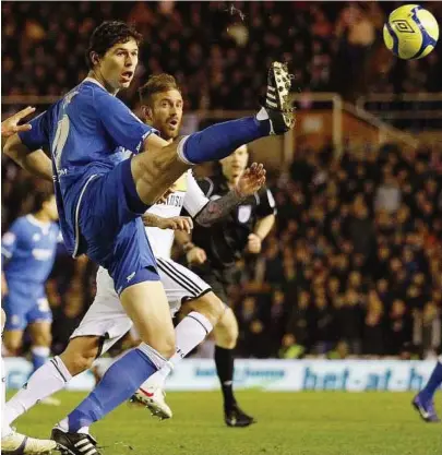  ??  ?? Shortlived joy: Birmingham’s Nikola Zigic (left) scored against Portsmouth on Tuesday. Portsmouth, however, fought back to win 4-1. — Reuters