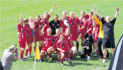  ??  ?? Bream Bay United Women’s football team celebrate their plate-winning match at Toll Stadium.