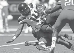  ?? TROY TAORMINA/ USA TODAY SPORTS ?? Arizona quarterbac­k Khalil Tate (14) is tackled by Houston linebacker Leroy Godfrey (4) near the goal line during the fourth quarter at TDECU Stadium in Houston on Saturday. Tate, who appeared to be limited after injuring his left ankle or calf in the first quarter, completed 24 of 45 passes for 341 yards.