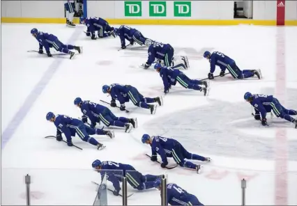  ??  ?? The Vancouver Canucks crawl along the ice after losing a split-squad scrimmage during training camp in Vancouver on July 15.