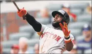  ?? John Bazemore / Associated Press ?? The Red Sox’s Brandon Phillips follows through on a game-winning two-run home run in the ninth inning against the Braves Wednesday in Atlanta.