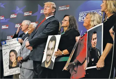  ?? AP/EVAN VUCCI ?? President Donald Trump stands Friday alongside family members affected by crime committed by undocument­ed immigrants at the South Court Auditorium on the White House complex in Washington.