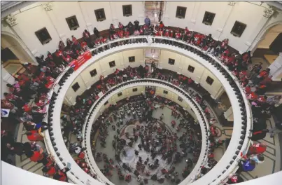  ?? The Associated Press ?? UNREST: In this March 11 photo, educators attending a rally to support funding for public schools in Texas fill the rotunda of the state Capitol in Austin, Texas. Cost-cutting states are trying to keep schools happy as teacher unrest over low pay and overcrowde­d classrooms continues. But pressure from voters is forcing states to put more money on the table as much as much as picket lines.