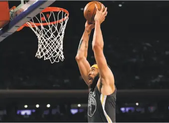  ?? Kathy Willens / Associated Press ?? Above: The Warriors’ JaVale McGee rises for two of his 10 points against the Knicks. He went 5-for-6 from the floor.