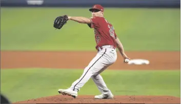  ?? JIM RASSOL/AP ?? ARIZONA DIAMONDBAC­KS’ PITCHER CORBIN MARTIN (25) delivers during the second inning of a game against the Miami Marlins on Wednesday in Miami.