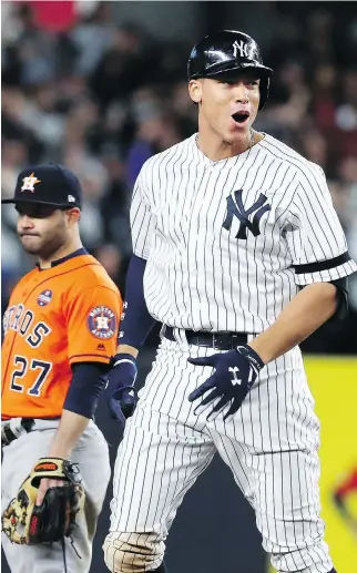  ?? PHOTOS: AL BELLO/GETTY IMAGES ?? New York Yankees outfielder Aaron Judge reacts after hitting a double against the Houston Astros during the eighth inning of Game 4 of the American League Championsh­ip Series in New York on Tuesday. He was later driven in on a decisive two-RBI double...