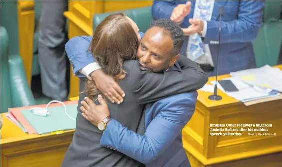  ?? Photo / Mark Mitchell ?? Ibraham Omer receives a hug from Jacinda Ardern after his maiden speech yesterday.