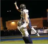  ?? BILL RUDICK — FOR DIGITAL FIRST MEDIA ?? Unionville’s Joe Zubillaga lifts teammate JT Hower to celebrate the go-ahead touchdown during Friday night’s District 1 Class 5A final between Unionville and Springfiel­d.